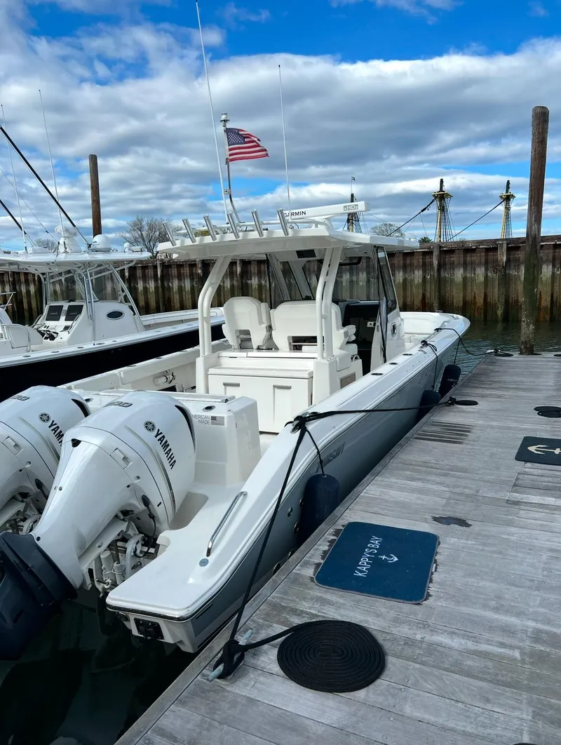 Slide: The Image of 2021 Pursuit S 328 Sport boat docked with twin Yamaha engines. - 11