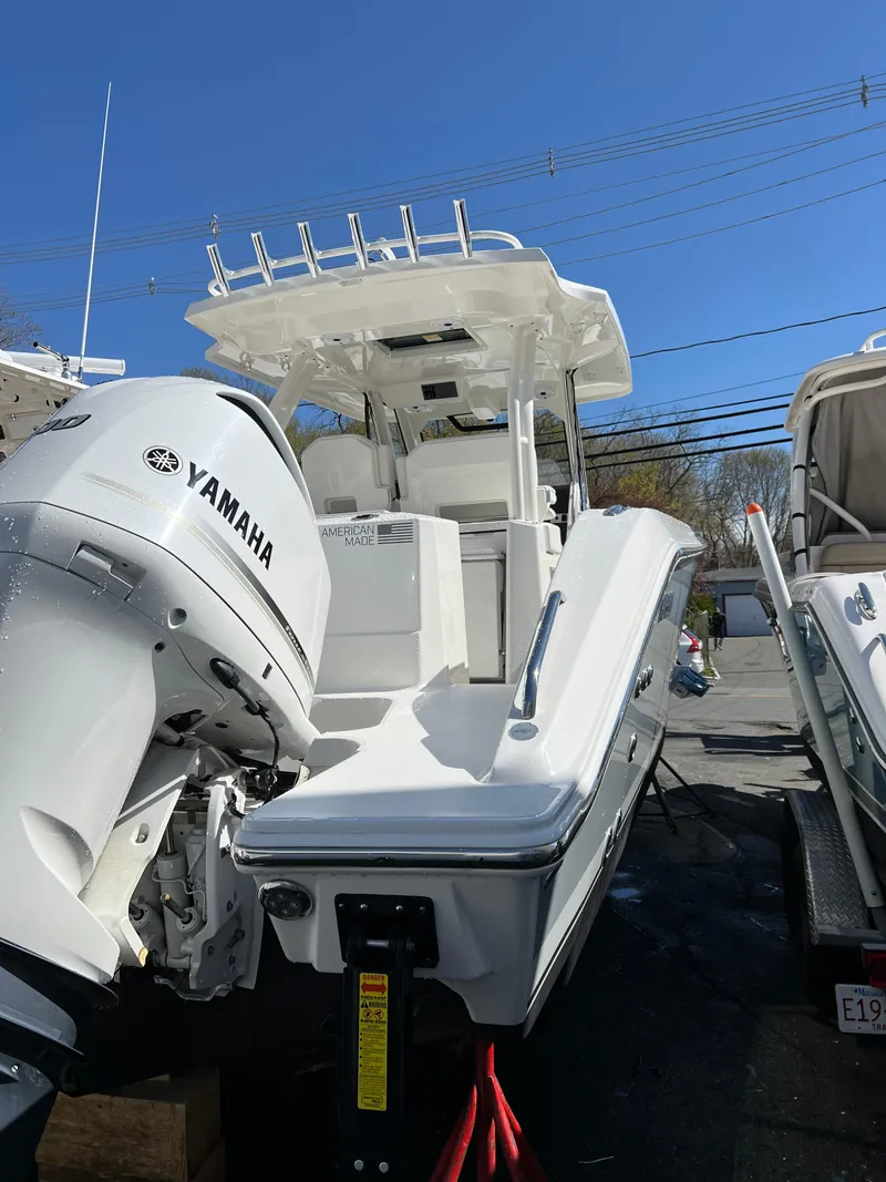 Slide: The Image of 2021 Pursuit S 328 Sport boat with Yamaha engine, docked under clear blue sky. - 13