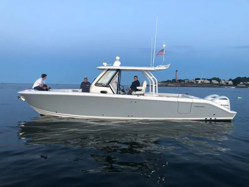Slide: The Image of 2021 Pursuit S 328 Sport boat on calm water at dusk. - 2
