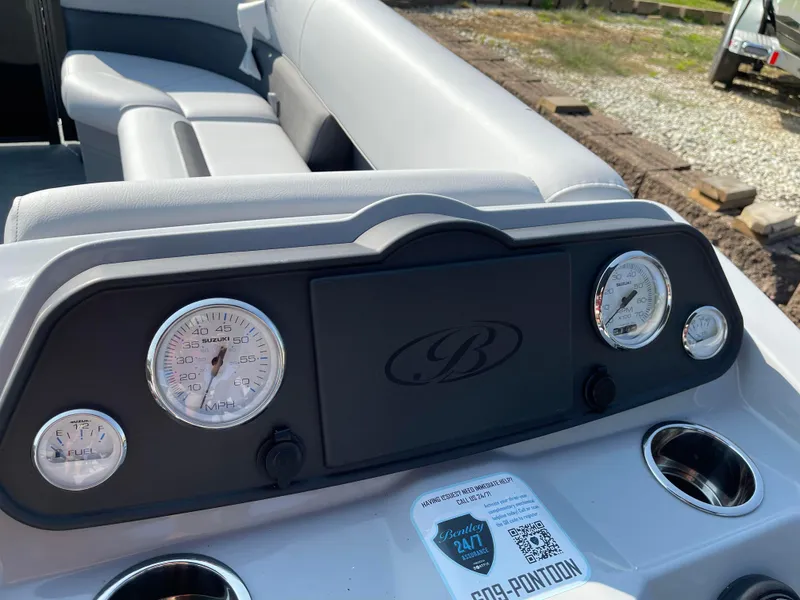 Slide: The Image of 2024 Bentley Pontoons LE 20 CW dashboard with gauges and cup holders. - 12