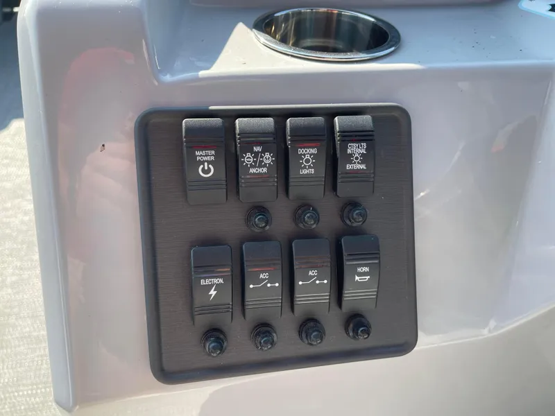 Slide: The Image of Control panel of 2024 Bentley Pontoons LE 20 CW with labeled switches. - 13