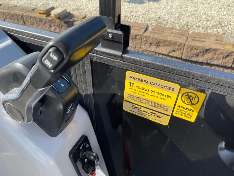 Slide: The Image of Close-up of 2024 Bentley Pontoons LE 20 CW control panel and capacity warning label. - 15