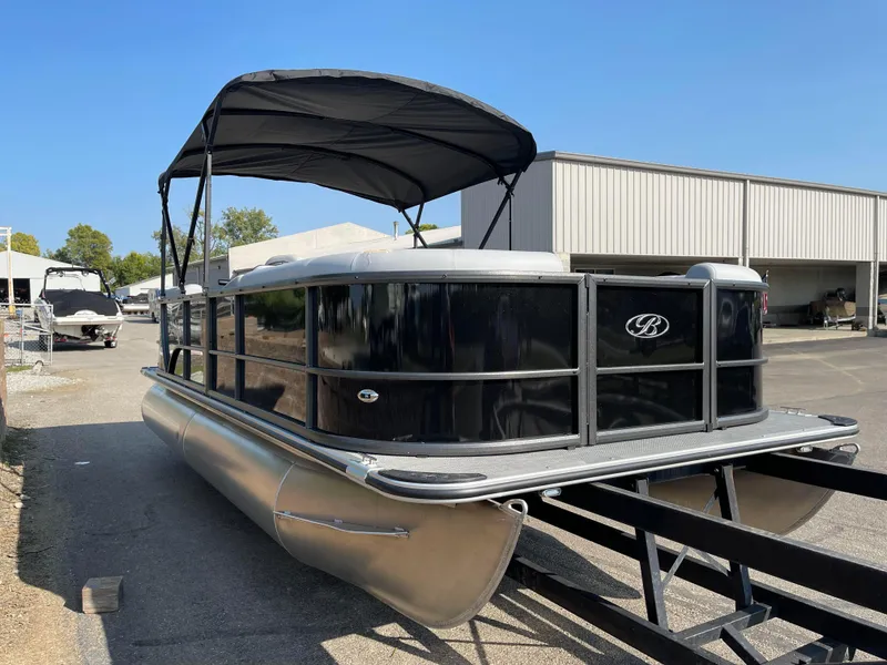 Slide: The Image of 2024 Bentley Pontoons LE 20 CW pontoon boat with canopy, parked outdoors. - 2