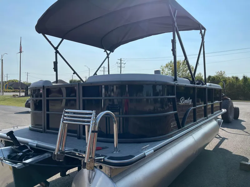 Slide: The Image of 2024 Bentley Pontoons LE 20 CW with canopy, parked outdoors. - 3