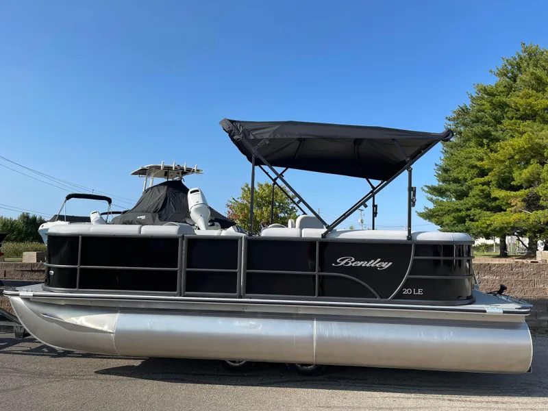 Slide: The Image of 2024 Bentley Pontoons LE 20 CW pontoon boat with black canopy and sleek design. - 6