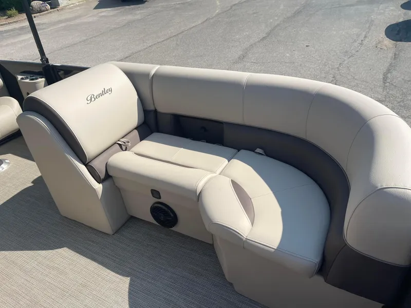 Slide: The Image of 2024 Bentley Pontoons Legacy 200 Navigator interior seating, beige upholstery, luxurious design. - 10