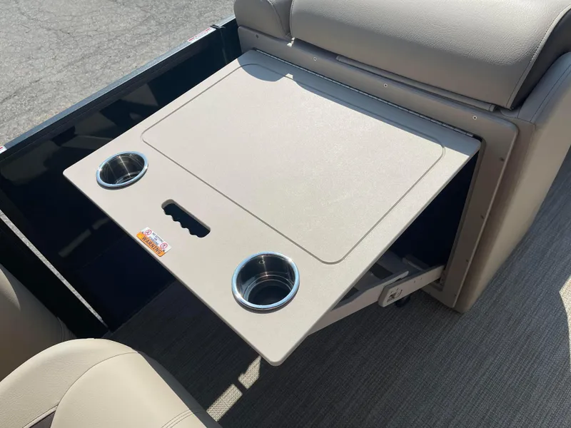 Slide: The Image of 2024 Bentley Pontoons Legacy 200 Navigator table with cup holders and beige seating. - 12