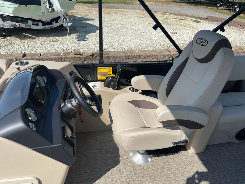 Slide: The Image of 2024 Bentley Pontoons Legacy 200 Navigator interior with captain's chair and control panel. - 14