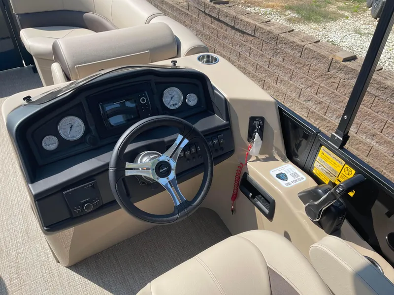 Slide: The Image of 2024 Bentley Pontoons Legacy 200 Navigator dashboard with steering wheel and controls. - 15