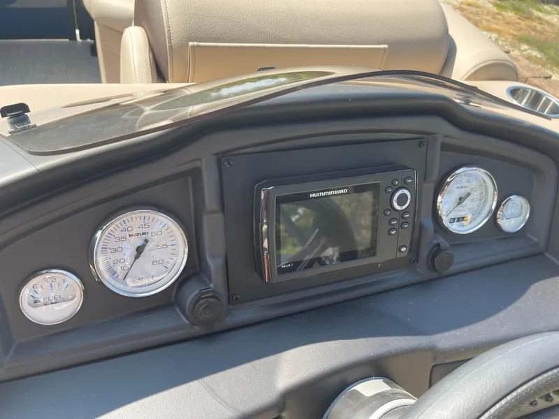 Slide: The Image of 2024 Bentley Pontoons Legacy 200 Navigator dashboard with gauges and navigation system. - 16