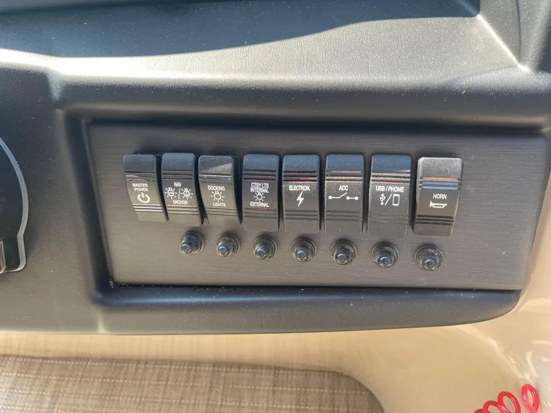 Slide: The Image of Control panel of 2024 Bentley Pontoons Legacy 200 Navigator with labeled switches. - 19
