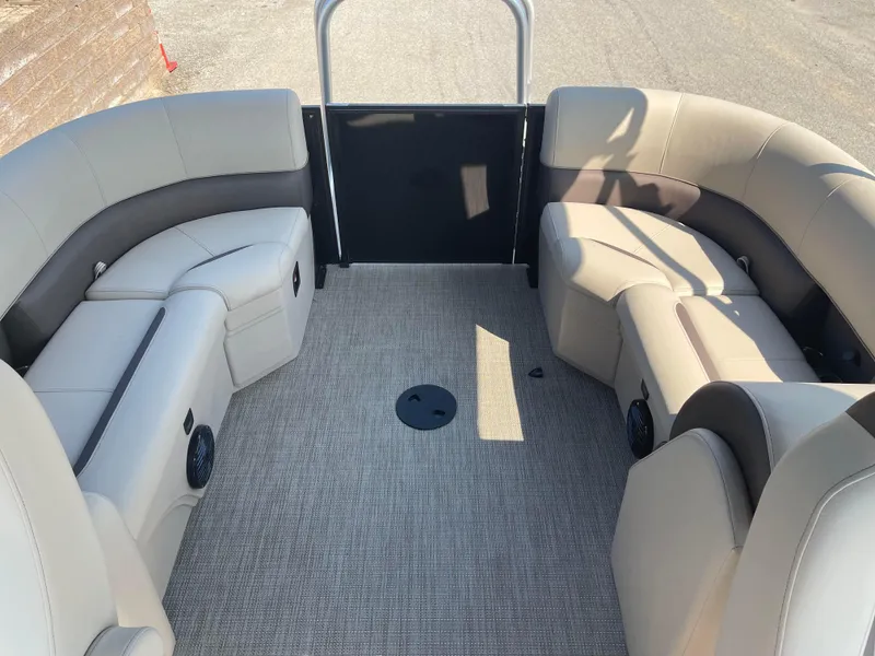 Slide: The Image of 2024 Bentley Pontoons Legacy 200 Navigator interior with beige seating and carpeted floor. - 22