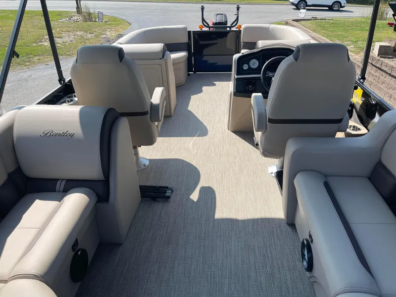 Slide: The Image of 2024 Bentley Pontoons Legacy 200 Navigator interior with beige seating and modern dashboard. - 25