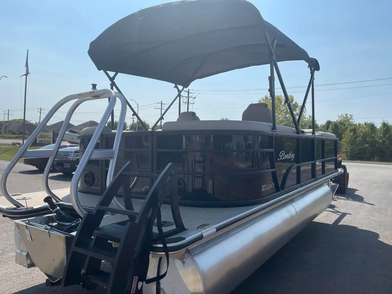 Slide: The Image of 2024 Bentley Pontoons Legacy 200 Navigator with canopy, parked outdoors. - 4