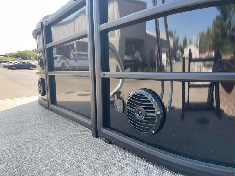 Slide: The Image of 2024 Bentley Pontoons Legacy 200 Navigator exterior with sleek black finish and speaker detail. - 5