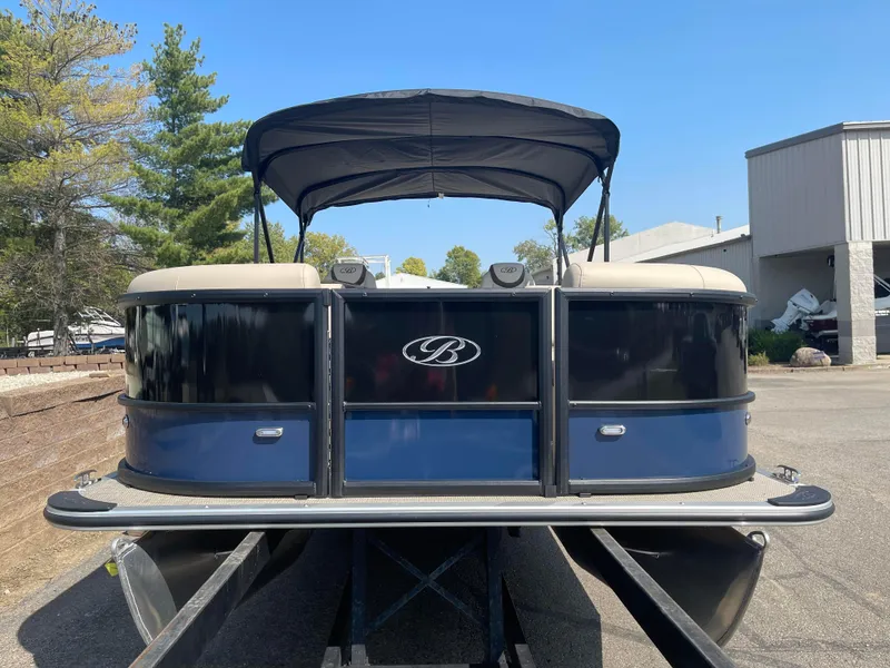 Slide: The Image of 2024 Bentley Pontoons Legacy 200 Navigator, black and blue, parked outdoors. - 7