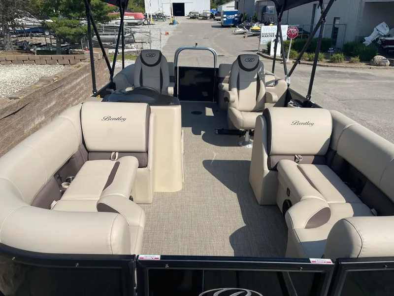Slide: The Image of 2024 Bentley Pontoons Legacy 200 Navigator with beige seating and spacious deck. - 8