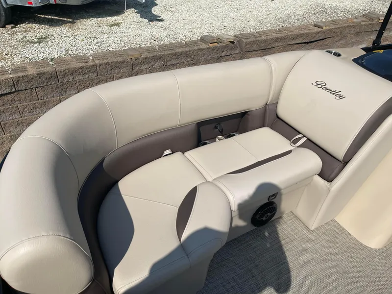 Slide: The Image of 2024 Bentley Pontoons Legacy 200 Navigator interior seating, beige and brown upholstery. - 9