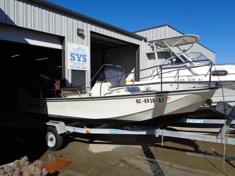 Slide: The Image of 1980 Boston Whaler 17 Montauk boat on trailer outside a garage. - 10