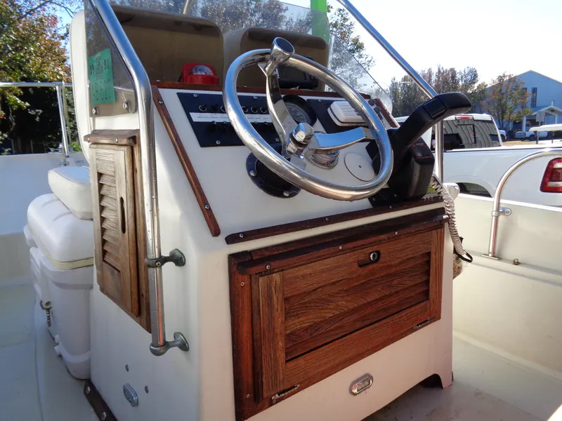 Slide: The Image of 1980 Boston Whaler 17 Montauk boat console with wooden accents and steering wheel. - 14
