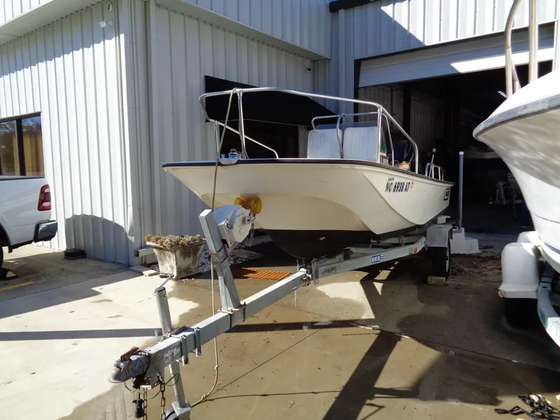 Slide: The Image of 1980 Boston Whaler 17 Montauk boat on trailer outside a metal building. - 3