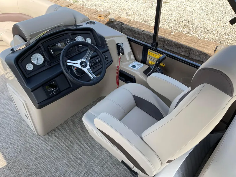 Slide: The Image of 2024 Bentley Pontoons Legacy 200 Navigator helm with modern controls and comfortable seating. - 14