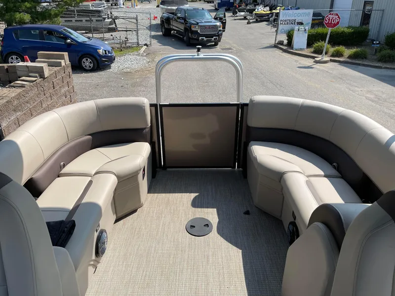 Slide: The Image of 2024 Bentley Pontoons Legacy 200 Navigator interior with plush seating and open deck view. - 21