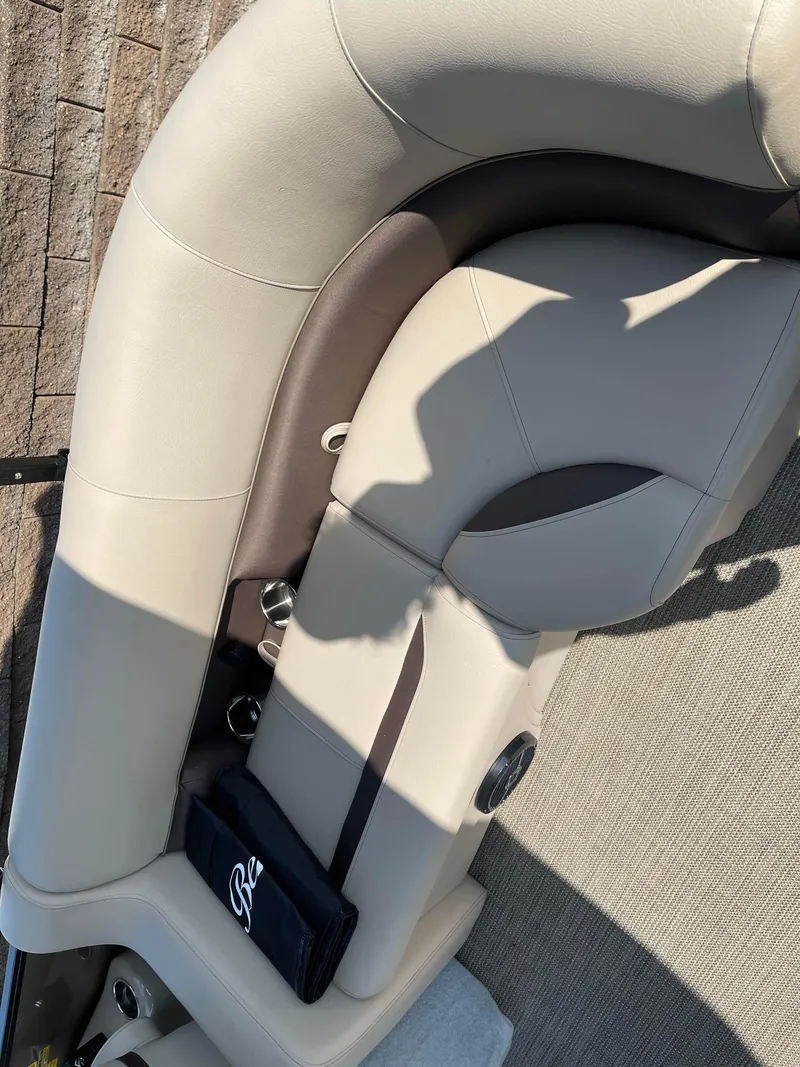 Slide: The Image of 2024 Bentley Pontoons Legacy 200 Navigator interior seating, beige and brown upholstery. - 22