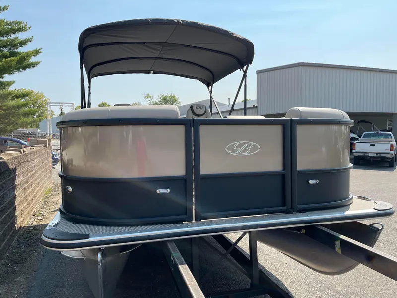 Slide: The Image of 2024 Bentley Pontoons Legacy 200 Navigator on trailer, outdoor setting. - 5