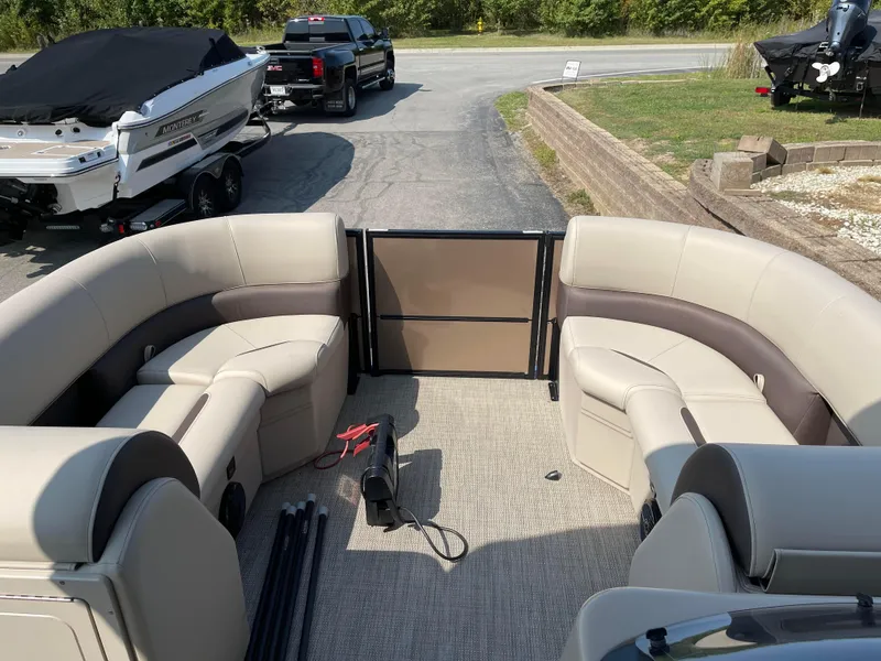Slide: The Image of 2024 Bentley Pontoons Legacy 200 Navigator interior with beige seating and open deck. - 9
