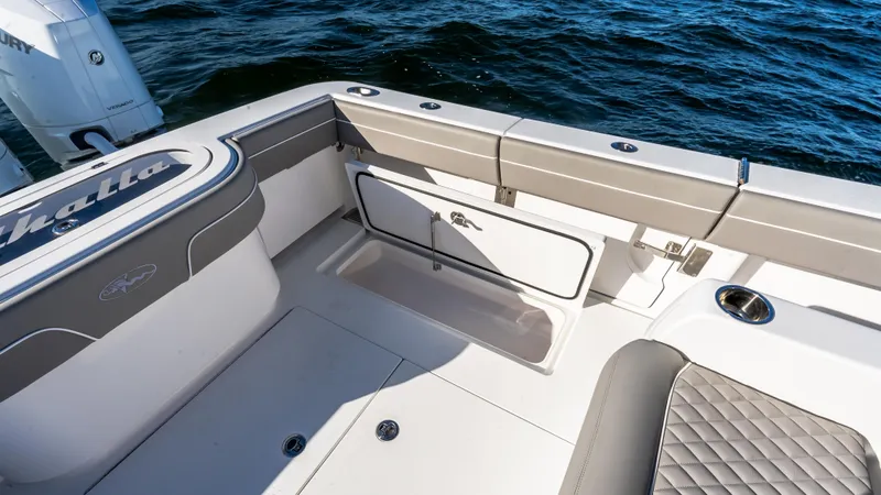 Slide: The Image of 2025 Valhalla Boatworks V-37 interior, featuring sleek seating and storage, on open water. - 15