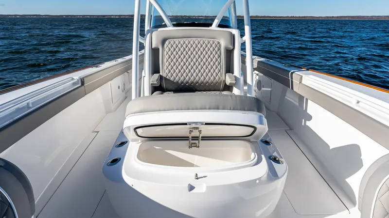 Slide: The Image of 2025 Valhalla Boatworks V-37 interior with cushioned seating and storage, on open water. - 42
