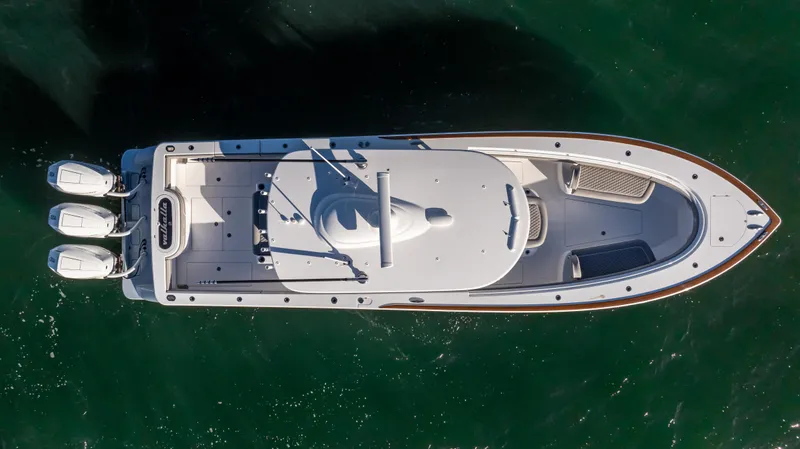 Slide: The Image of Aerial view of 2025 Valhalla Boatworks V-37 on water, showcasing sleek design and triple engines. - 7