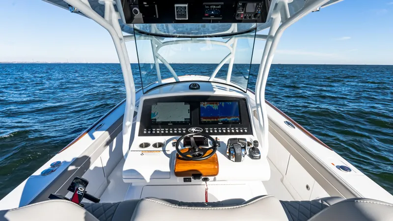 Slide: The Image of 2025 Valhalla Boatworks V-37 helm with advanced navigation system on open water. - 23