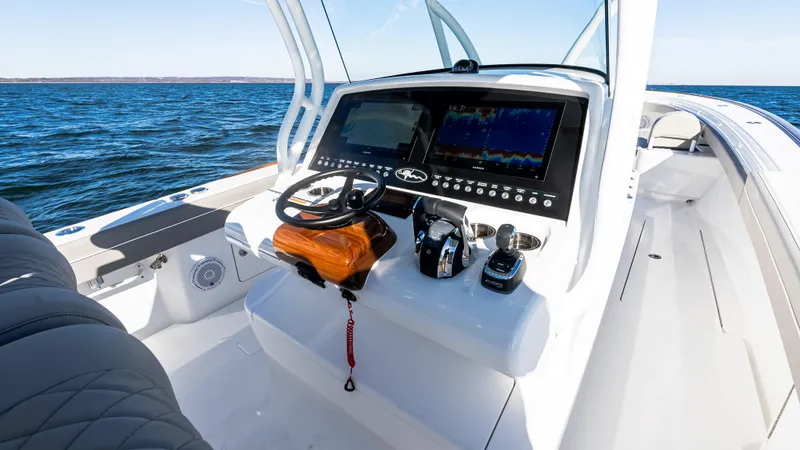 Slide: The Image of 2025 Valhalla Boatworks V-37 helm with advanced navigation system on open water. - 27