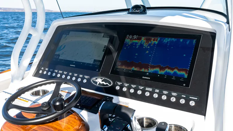 Slide: The Image of 2025 Valhalla Boatworks V-37 dashboard with dual navigation screens and steering wheel. - 28