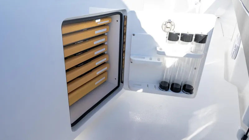 Slide: The Image of 2025 Valhalla Boatworks V-37 storage compartment with organized shelves and containers. - 31