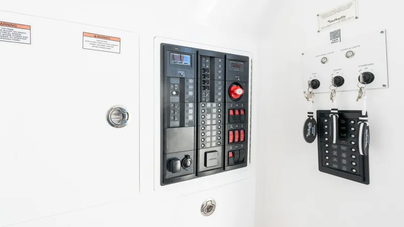 Slide: The Image of Electrical control panel of 2025 Valhalla Boatworks V-37, featuring switches and key controls. - 49