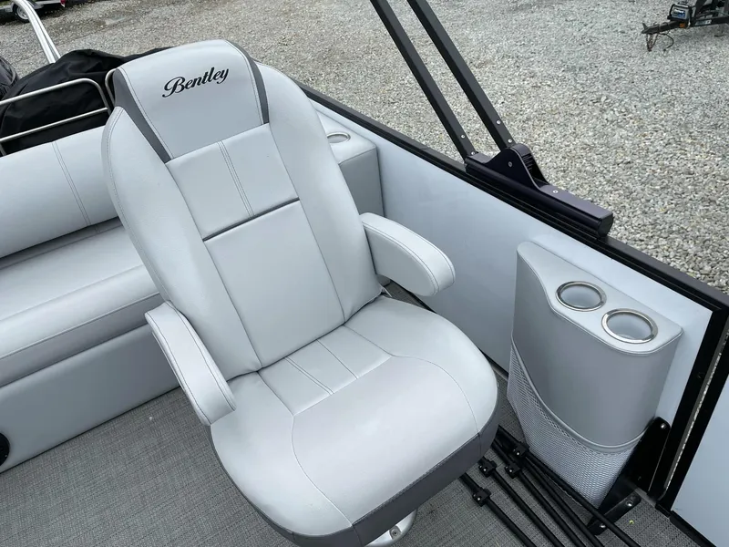 Slide: The Image of 2022 Bentley Pontoons Elite 223 Swingback interior with luxurious seating and cup holders. - 13