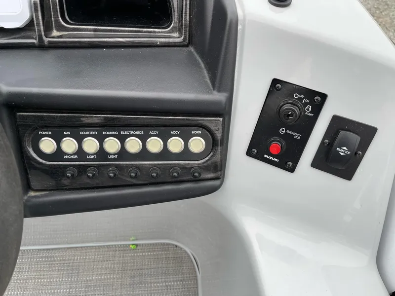 Slide: The Image of Control panel of 2022 Bentley Pontoons Elite 223 Swingback with various switches and buttons. - 18