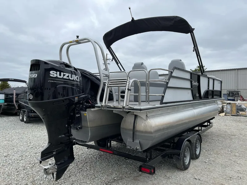 Slide: The Image of 2022 Bentley Pontoons Elite 223 Swingback with Suzuki engine on trailer. - 2