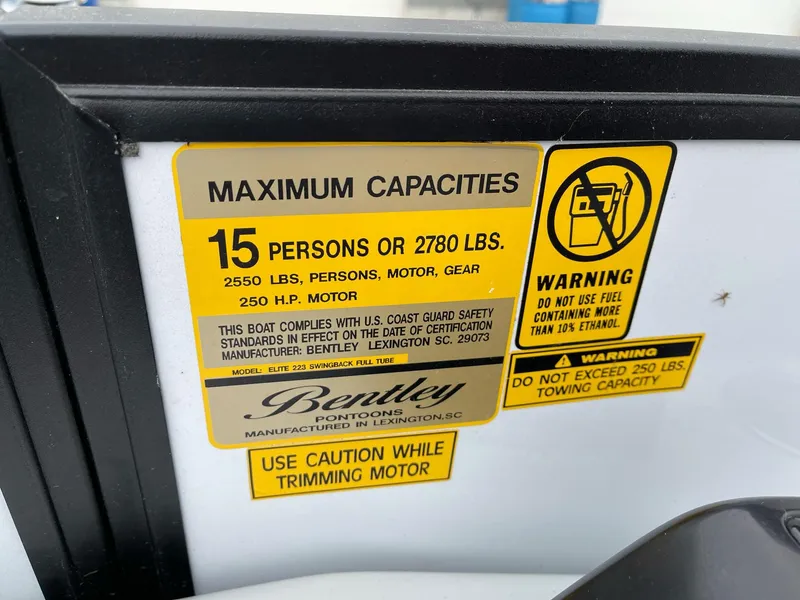 Slide: The Image of Capacity warning label on 2022 Bentley Pontoons Elite 223 Swingback boat. - 20