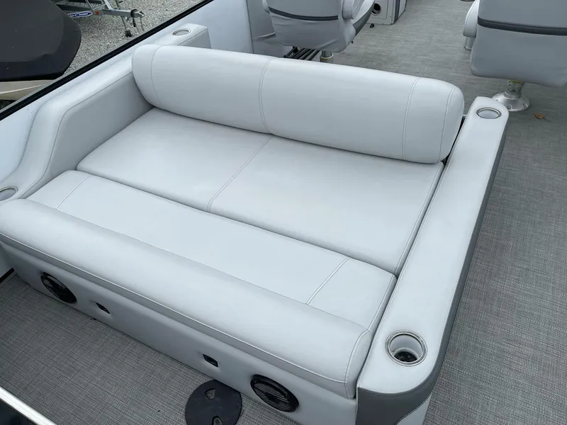 Slide: The Image of 2022 Bentley Pontoons Elite 223 Swingback with luxurious seating and cup holders. - 22