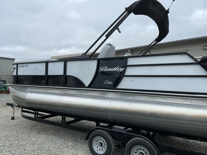 Slide: The Image of 2022 Bentley Pontoons Elite 223 Swingback on trailer, side view. - 6