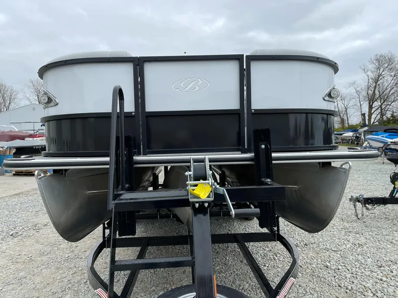 Slide: The Image of 2022 Bentley Pontoons Elite 223 Swingback on trailer, front view, overcast sky. - 8