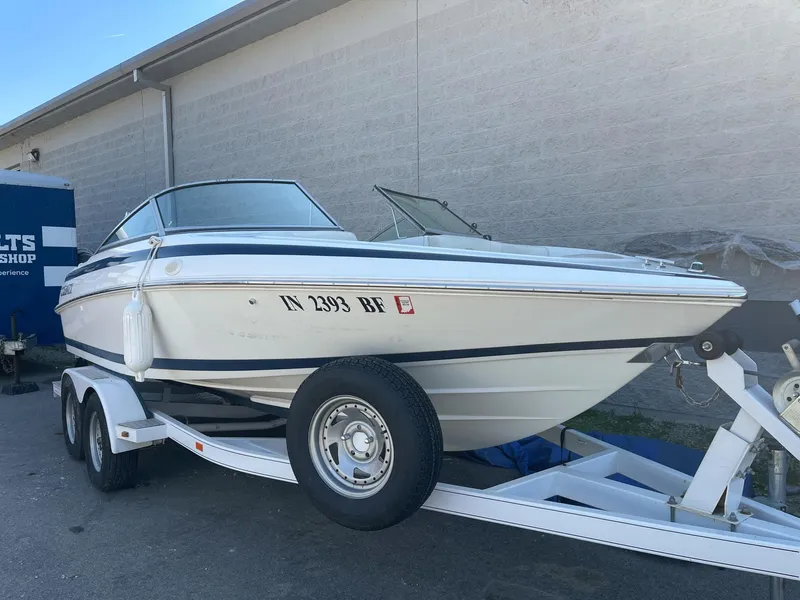 The Image of 1996 Cobalt 190 Bowrider boat on trailer, parked outdoors. - 0