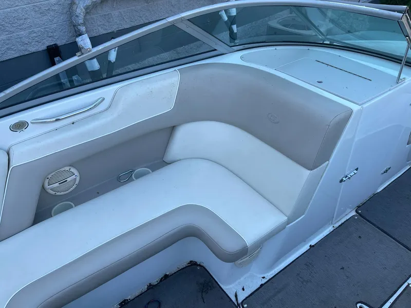 Slide: The Image of 1996 Cobalt 190 Bowrider boat interior with beige seating and cup holders. - 16
