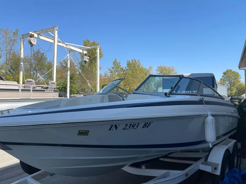 Slide: The Image of 1996 Cobalt 190 Bowrider boat on trailer, parked outdoors under clear blue sky. - 3