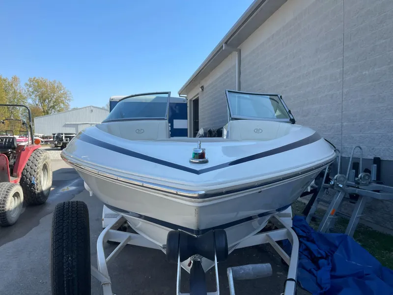 Slide: The Image of 1996 Cobalt 190 Bowrider boat on trailer, parked outdoors. - 4
