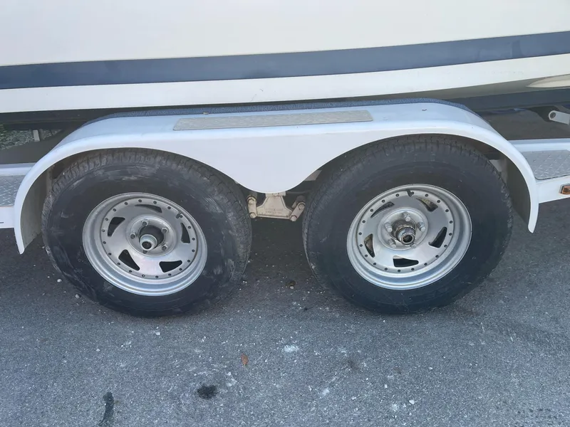 Slide: The Image of Trailer wheels of a 1996 Cobalt 190 Bowrider boat on pavement. - 7